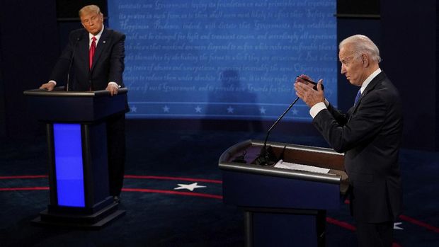 Democratic presidential candidate former Vice President Joe Biden answers a question as President Donald Trump listens during the second and final presidential debate Thursday, Oct. 22, 2020, at Belmont University in Nashville, Tenn. (AP Photo/Morry Gash, Pool)
