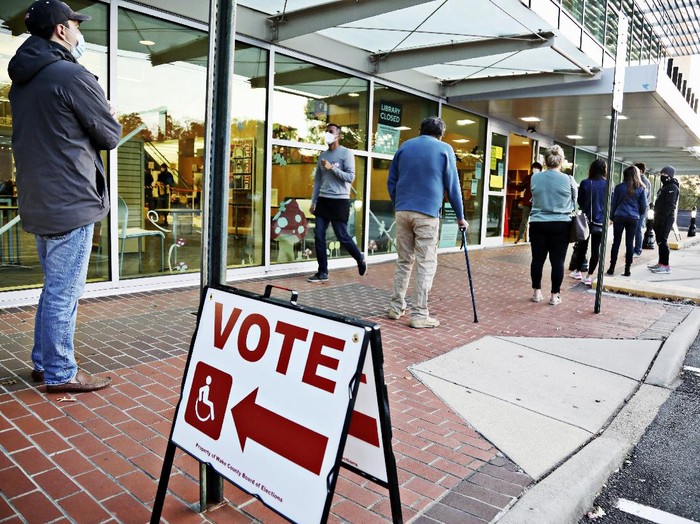A steady line of voters wait outside of Cameron Village Library in Raleigh, N.C. early Tuesday morning, Nov. 3, 2020, to cast their ballot on Election Day.  (Juli Leonard/The News & Observer via AP)