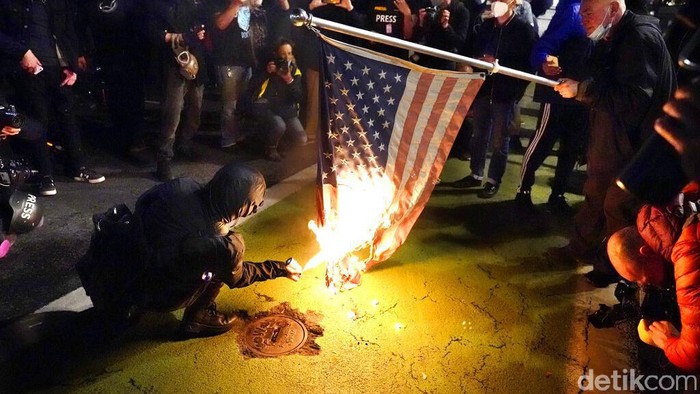 Bakar bedera Amerika Seorang pengunjuk rasa menyalakan bendera Amerika dengan api saat demonstrasi Rabu, 4 November 2020, di Portland, Ore.
Para demonstran turun ke jalanan berbagai kota dan wilayah di Amerika Serikat (AS) untuk menyerukan agar seluruh suara dalam pilpres AS dihitung hingga tuntas.