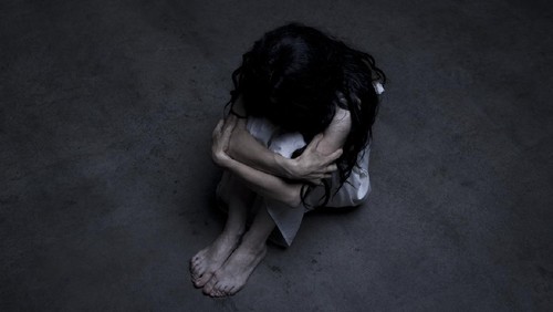 Lonely girl sitting on the floor