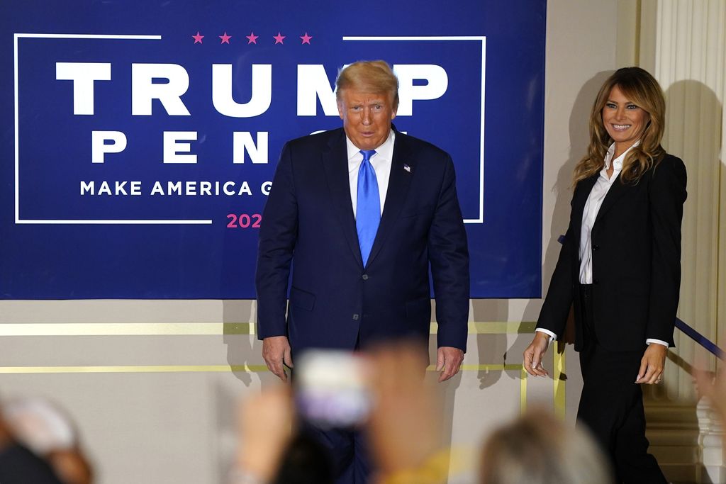 President Donald Trump arrives with first lady Melania Trump to speak in the East Room of the White House, early Wednesday, Nov. 4, 2020, in Washington. (AP Photo/Evan Vucci)