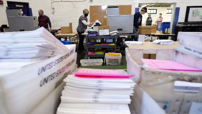 Chester County election workers scan mail-in and absentee ballots for the 2020 general election in the United States at West Chester University, Wednesday, Nov. 4, 2020, in West Chester, Pa. (AP Photo/Matt Slocum)