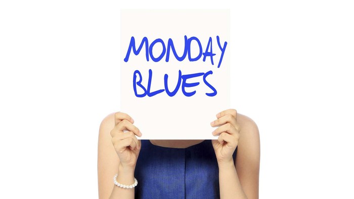 A woman showing a poster indicating Monday Blues