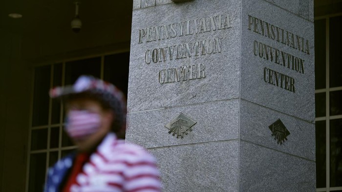 A supporter of President Donald Trump stands outside the Pennsylvania Convention Center where votes are being counted, Thursday, Nov. 5, 2020, in Philadelphia, following Tuesdays election. (AP Photo/Matt Slocum)