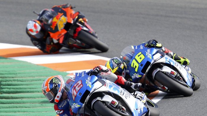 Spains rider Alex Rins of the Team SUZUKI ECSTAR leads on Spains rider Joan Mir of the Team SUZUKI ECSTARand Spains rider Pol Espargaro of the Red Bull KTM Factory Racing in the MotoGP race during the European Grand Prix in Valencia, Spain, Sunday, Nov. 8, 2020. (AP Photo/Alberto Saiz)