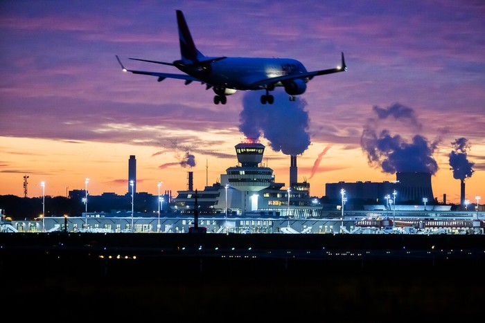 The last Lufthansa flight of the Airbus A350 aircraft from Tegel Airport is taxiing to the take-off field as it is bid farewell by the airport fire brigade with a fountain of water in Berlin, Germany, Saturday, Nov. 7, 2020. The final flight is scheduled for Sunday. (Fabian Sommer/dpa via AP)