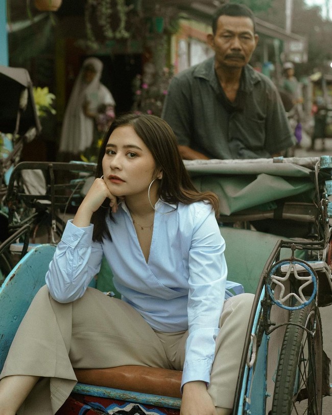 Tak ketinggalan dalam salah satu fotonya itu Prilly juga terlihat sedang naik becak. Prilly tampak mengenakan atasan kemeja berwarna biru muda dengan celana bahan warna coklat. Foto: Instagram/@prillylatuconsina96