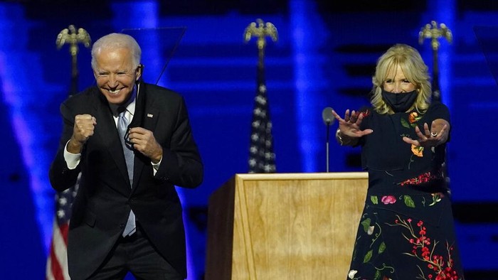 President-elect Joe Biden and wife Jill Biden gesture to supporters Saturday, Nov. 7, 2020, in Wilmington, Del. (AP Photo/Andrew Harnik, Pool)