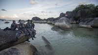 Beberapa taruna tampak asyik menikmati senja sambil bersantai duduk di atas bebatuan besar.