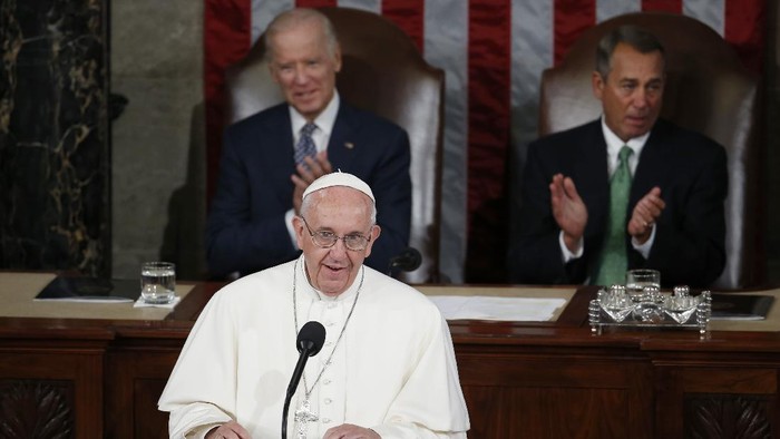 FILE - In this Thursday, Sept. 24, 2015 file photo, Pope Francis addresses a joint meeting of Congress on Capitol Hill in Washington, making history as the first pontiff to do so. Listening behind the pope are Vice President Joe Biden and House Speaker John Boehner of Ohio. President-elect Joe Biden, a lifelong Roman Catholic, spoke to Pope Francis on Thursday, Nov. 12, 2020, despite President Donald Trump refusing to concede. Trump claims — without evidence — that the election was stolen from him through massive but unspecified acts of fraud. (AP Photo/Carolyn Kaster)