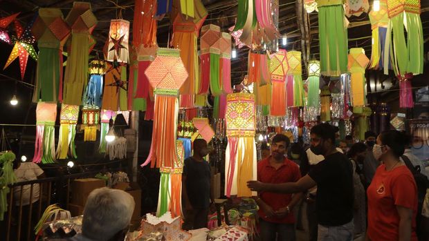 Lanterns are displayed for sale as people shop ahead of Diwali festival in Mumbai, India, Thursday, Nov.12, 2020. India's tally of coronavirus cases is currently the second largest in the world behind the United States. The government warns that the situation can worsen due to people crowding markets for festival shopping. (AP Photo/Rajanish Kakade)