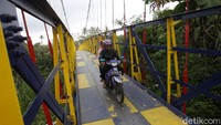 Pengendara melintas di Jembatan Gantung Mangunsuko, Dukun, Magelang, Jawa Tengah, Jumat (13/11/2020).   