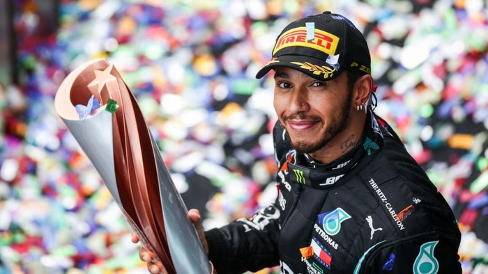Lewis Hamilton ISTANBUL, TURKEY - NOVEMBER 15: Race winner Lewis Hamilton of Great Britain and Mercedes GP celebrates winning a 7th F1 World Drivers Championship on the podium during the F1 Grand Prix of Turkey at Intercity Istanbul Park on November 15, 2020 in Istanbul, Turkey. (Photo by Tolga Bozoglu - Pool/Getty Images)
