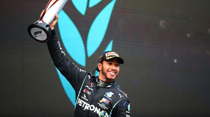 ISTANBUL, TURKEY - NOVEMBER 15: Race winner Lewis Hamilton of Great Britain and Mercedes GP celebrates winning a 7th F1 World Drivers Championship on the podium during the F1 Grand Prix of Turkey at Intercity Istanbul Park on November 15, 2020 in Istanbul, Turkey. (Photo by Tolga Bozoglu - Pool/Getty Images)