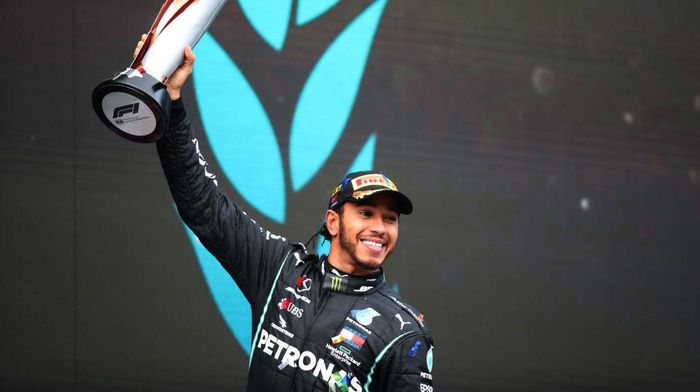Lewis Hamilton ISTANBUL, TURKEY - NOVEMBER 15: Race winner Lewis Hamilton of Great Britain and Mercedes GP celebrates winning a 7th F1 World Drivers Championship on the podium during the F1 Grand Prix of Turkey at Intercity Istanbul Park on November 15, 2020 in Istanbul, Turkey. (Photo by Tolga Bozoglu - Pool/Getty Images)