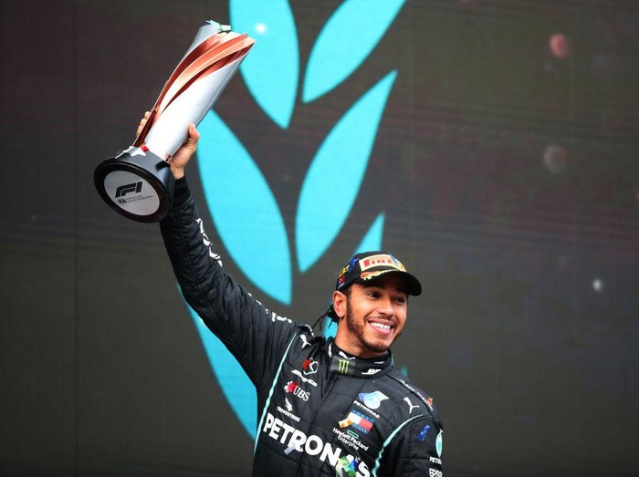 ISTANBUL, TURKEY - NOVEMBER 15: Race winner Lewis Hamilton of Great Britain and Mercedes GP celebrates winning a 7th F1 World Drivers Championship on the podium during the F1 Grand Prix of Turkey at Intercity Istanbul Park on November 15, 2020 in Istanbul, Turkey. (Photo by Tolga Bozoglu - Pool/Getty Images)