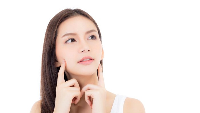 945363202 Portrait of beautiful asian woman makeup of cosmetic, girl hand touch cheek and smile attractive, face of beauty perfect with wellness isolated on white background with skin healthcare concept.