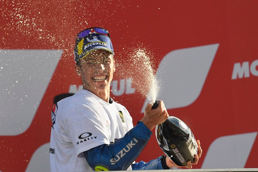 VALENCIA, SPAIN - NOVEMBER 15: Joan Mir of Spain and Team Suzuki ECSTAR  celebrates with champagne the victory of 2020 championship of MotoGp season  on the podium at the end of the MotoGp race during the MotoGP of Comunitat Valenciana at Comunitat Valenciana Ricardo Tormo Circuit on November 15, 2020 in Valencia, Spain. (Photo by Mirco Lazzari gp/Getty Images)