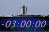 The countdown clock is stopped at a three-hour built in hold as a SpaceX Falcon 9 rocket, with the companys Crew Dragon capsule attached, sits on the launch pad at Launch Complex 39A Sunday, Nov. 15, 2020, at the Kennedy Space Center in Cape Canaveral, Fla. Four astronauts will fly on the SpaceX Crew-1 mission to the International Space Station scheduled for launch on later today. (AP Photo/Chris OMeara)
