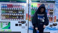 Jalan-jalan ke Jepang, Amelia tak lewatkan pose di depan vending machine yang ikonik. Gayanya santai dan keren ya? Foto: Instagram ameliagray