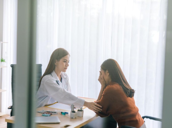 Doctor comforting his depressed patient
