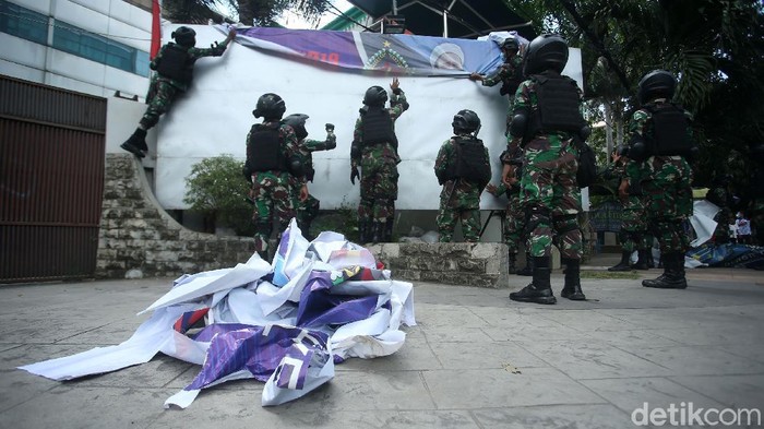 Bawa Panser Prajurit TNI Copot Spanduk Habib Rizieq Sejumlah personel TNI menurunkan spanduk besar bergambarkan Habib Rizieq di Jakarta, Jumat (20/11/2020). Mereka turut membawa panser saat beraksi.