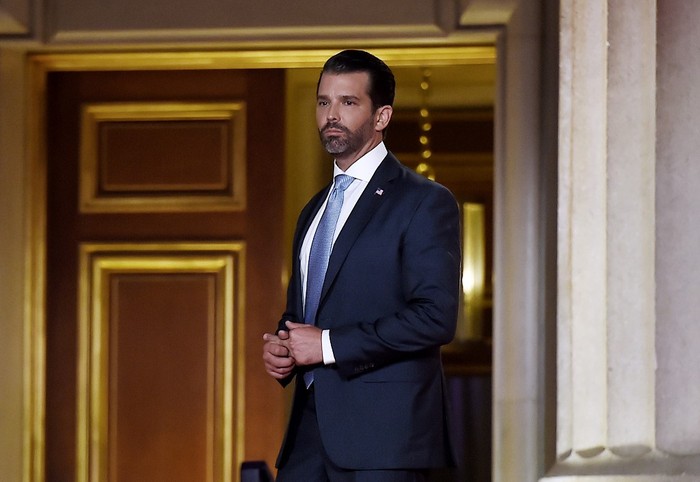 Donald Trump Jr. center, stops to take a photograph with his phone during his familys arrival at Andrews Air Force Base, Md., Sunday, April 1, 2018, as Vanessa Trump, center right, picks up their son Spencer to place him in the minivan. The Trump family was returning to Washington after spending Easter weekend at President Donald Trumps Mar-a-Lago estate in Palm Beach, Fla. (AP Photo/Pablo Martinez Monsivais)