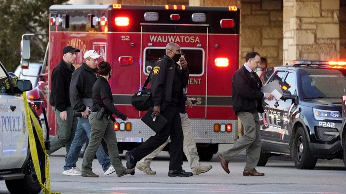 Police officials walk to the Mayfair Mall, Friday, Nov. 20, 2020, in Wauwatosa, Wis. Multiple people were shot Friday afternoon at the mall and police are still searching for the shooter. (AP Photo/Nam Y. Huh)