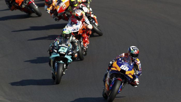 MotoGP Portugal MotoGP rider Miguel Oliveira of Portugal steers his motorcycle ahead of Franco Morbidelli of Italy and Jack Miller of Australia during the MotoGP race of the Portuguese Motorcycle Grand Prix, the last race of the season, at the Algarve International circuit near Portimao, Portugal, Sunday, Nov. 22, 2020. (AP Photo/Armando Franca)