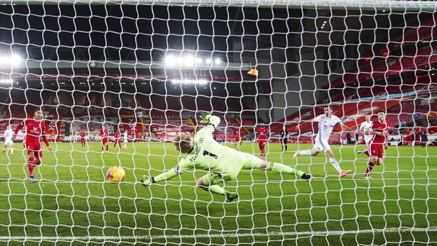 Liverpool vs Leicester City Liverpool's Diogo Jota, right, scores his sides second goal past Leicester's goalkeeper Kasper Schmeichel, center, during the English Premier League soccer match between Liverpool and Leicester City at Anfield stadium in Liverpool, England, Sunday, Nov. 22, 2020. (AP Photo/Jon Super)