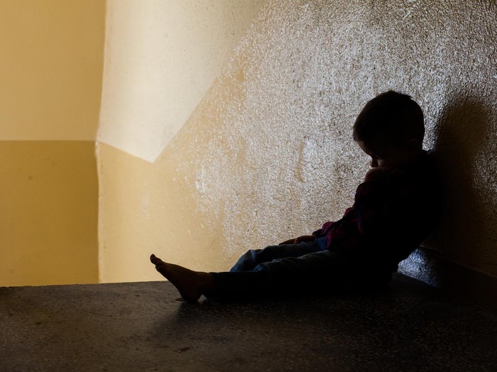 eye of boy through key whole, child abuse concept