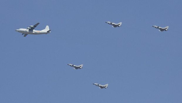 A Y-9 transport plane and J-10 fighter jets fly in formation during a parade commemorating the 70th anniversary of Japan's surrender during World War II in Beijing, Thursday, Sept. 3, 2015. The spectacle involved more than 12,000 troops, 500 pieces of military hardware and 200 aircraft of various types, representing what military officials say is the Chinese military's most cutting-edge technology. (AP Photo/Mark Schiefelbein)