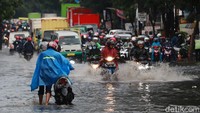 Arus lalu lintas di jalan tersebut mengalami kemacetan karena banyak kendaraan yang berhenti sebelum dan sesudah genangan air.