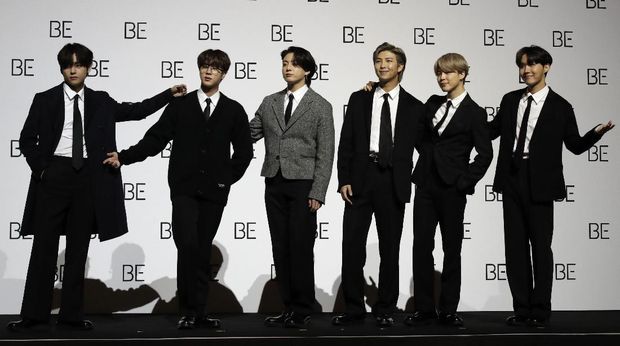 Members of South Korean K-pop band BTS pose for photographers during a press conference to introduce their new album 