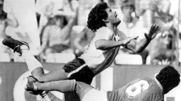 FILE - In this June 29, 1982 file photo, Diego Maradona is tackled by Italy's Claudio Gentile during a World Cup second-round match between Italy and Argentina at Sarra Stadium in Barcelona, Spain. The Argentine soccer great who was among the best players ever and who led his country to the 1986 World Cup title before later struggling with cocaine use and obesity, died from a heart attack on Wednesday, Nov. 25, 2020, at his home in Buenos Aires. He was 60. (AP Photo, File)
