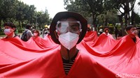Para peserta menggelar aksi dengan menerapkan protokol kesehatan seperti memakai masker dan face shield.