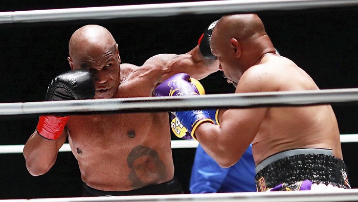 In a photo provided by Triller, Mike Tyson throws a punch during the third round against Roy Jones Jr. in an exhibition boxing bout Saturday, Nov. 28, 2020, in Los Angeles. The bout was unofficially ruled a draw by the WBC judges at ringside. Tyson and Jones fought eight two-minute rounds, and both emerged smiling and apparently healthy from a highly unusual event. (Joe Scarnici/Triller via AP)