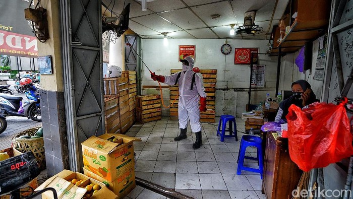 Petugas PMI menyemprotkan disinfektan di area Pasar Gede Solo. Penyemprotan dilakukan usai 8 orang pedagang di pasar itu terkonfirmasi positif COVID-19.