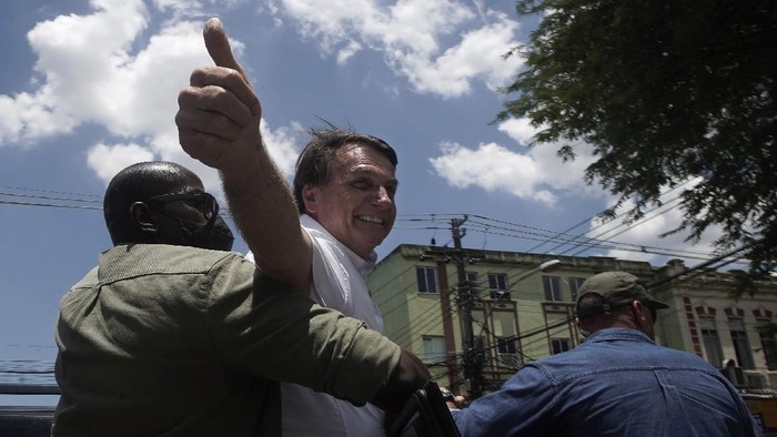 Brazils President Jair Bolsonaro greets supporters after voting during the run-off municipal elections in Rio de Janeiro, Brazil, Sunday, Nov. 29, 2020. Bolsonaro, who sometimes has embraced the label 