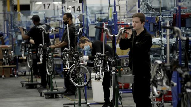 Brompton folding bicycles are assembled by hand at the Brompton factory in west London, Tuesday, Nov. 24, 2020. The team at Brompton Bicycles company thought they were prepared for Britain's Brexit split with Europe, but they face uncertainty about supplies and unexpected new competition from China, all amid a global COVID pandemic.(AP Photo/Matt Dunham)