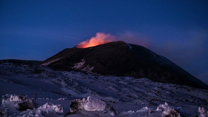 CATANIA, ITALY - DECEMBER 01: Night view of the Strombolian activity of the summit craters of the volcano Etna, photographed from an altitude of 2900 metres, with explosions and lapilli throwing visible on December 01, 2020 in Catania, Italy. Etna in activity again: two active mouths with vapour emissions, ash and frequent Strombolian explosions throwing incandescent material from the cone of the South-East Crater. (Photo by Fabrizio Villa/Getty Images)