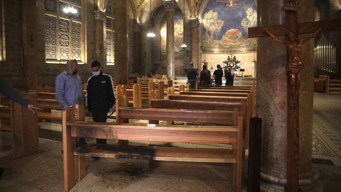 A burned pew is seen at the Church of All Nations in the Garden of Gethsemane, in east Jerusalem, Friday, Dec. 4, 2020. Israeli police said Friday they arrested a Jewish man after he poured out a 
