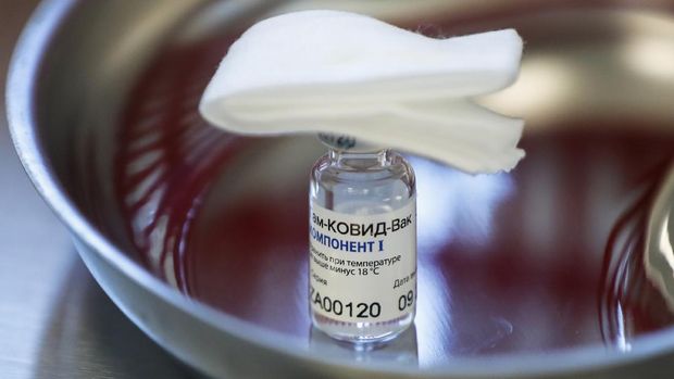 A vial with Russia's Sputnik V coronavirus vaccine in a medical room, in Moscow, Russia, Saturday, Dec. 5, 2020. Thousands of doctors, teachers and others in high-risk groups have signed up for COVID-19 vaccinations in Moscow starting Saturday, a precursor to a sweeping Russia-wide immunization effort. (AP Photo/Pavel Golovkin)
