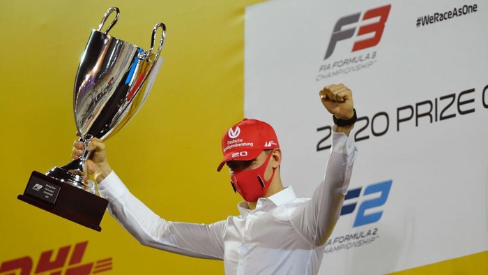 BAHRAIN, BAHRAIN - DECEMBER 06: 2020 F2 Champion Mick Schumacher of Germany and Prema Racing is presented with his trophy during the Formula 2 Championship Prize Giving Ceremony at Bahrain International Circuit on December 06, 2020 in Bahrain, Bahrain. (Photo by Rudy Carezzevoli/Getty Images)
