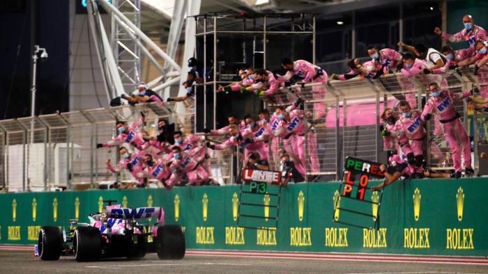 Sergio Perez BAHRAIN, BAHRAIN - DECEMBER 06: Race winner Sergio Perez of Mexico driving the (11) Racing Point RP20 Mercedes takes the flag as teammates celebrate during the F1 Grand Prix of Sakhir at Bahrain International Circuit on December 06, 2020 in Bahrain, Bahrain. (Photo by Hamad I Mohammed - Pool/Getty Images)
