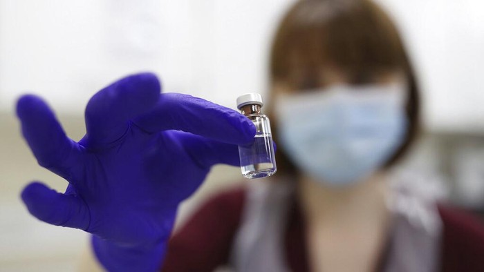 90 year old Margaret Keenan, the first patient in the UK to receive the Pfizer-BioNTech COVID-19 vaccine, administered by nurse May Parsons at University Hospital, Coventry, England, Tuesday Dec. 8, 2020. The United Kingdom, one of the countries hardest hit by the coronavirus, is beginning its vaccination campaign, a key step toward eventually ending the pandemic. (Jacob King/Pool via AP)
