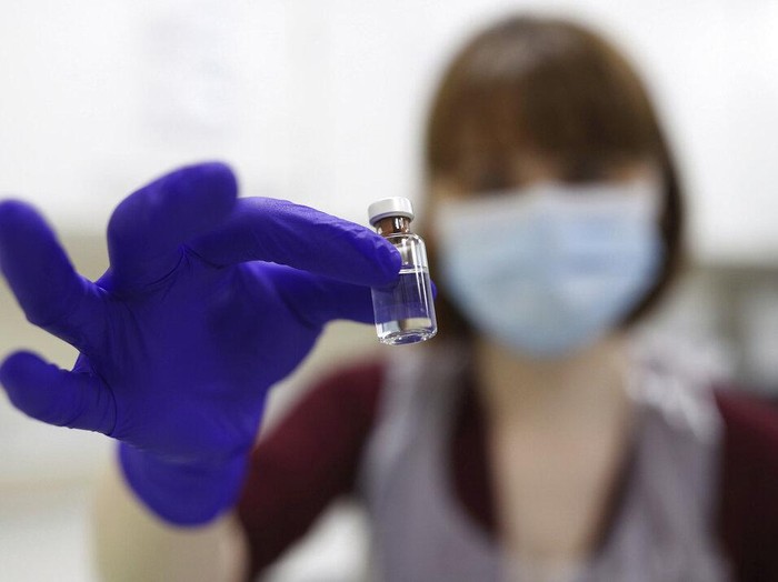 90 year old Margaret Keenan, the first patient in the UK to receive the Pfizer-BioNTech COVID-19 vaccine, administered by nurse May Parsons at University Hospital, Coventry, England, Tuesday Dec. 8, 2020. The United Kingdom, one of the countries hardest hit by the coronavirus, is beginning its vaccination campaign, a key step toward eventually ending the pandemic. (Jacob King/Pool via AP)