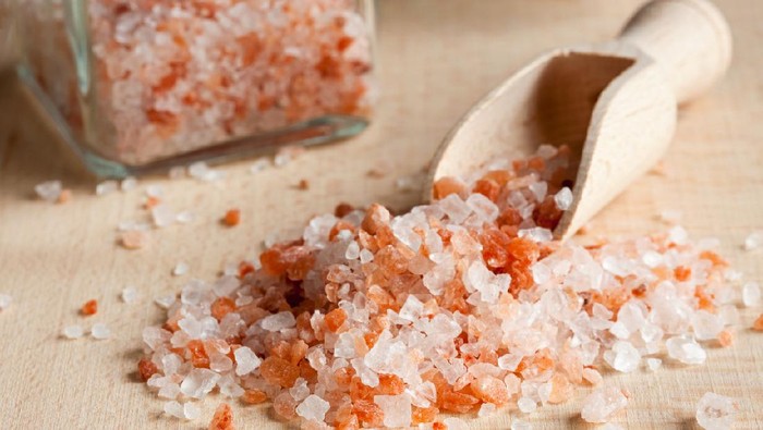 Pink Himalayan sea salt on a wooden background