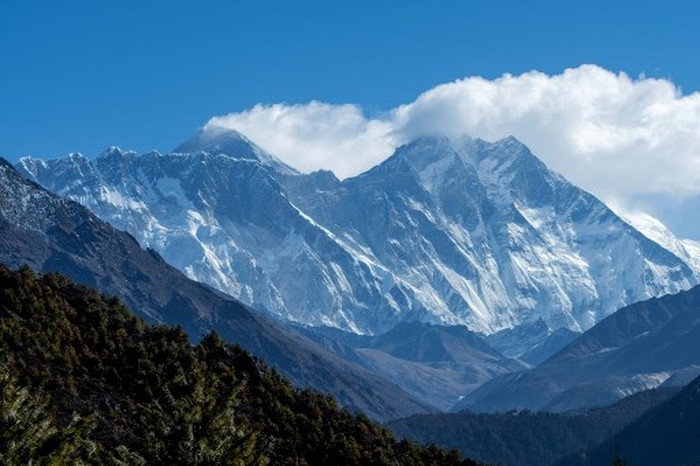 Anggota staf Departemen Survei menghadiri pengumuman virtual soal ketinggian Gunung Everest di Kathmandu pada 8 Desember 2020. Keputusan itu mengakhiri debat selama beberapa dekade dengan diputuskan ketingguan Gunung Everest kini 8.848.86 mdpl atau 86 cm lebih tinggi ketimbang yang ditetapkan Nepal sebelumnya atau 4 meter di bawah pengakuan resmi China sebelumnya. (Photo by PRAKASH MATHEMA / AFP)