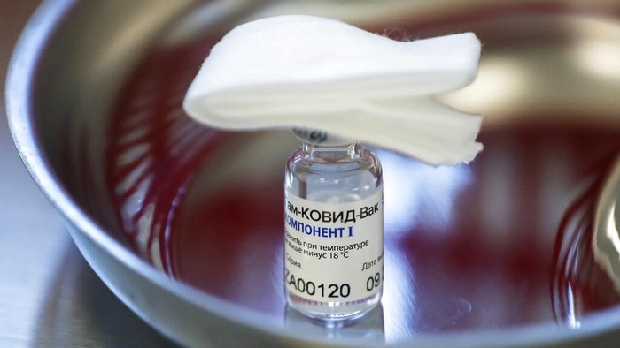 A medical worker moves a box of Russias Sputnik V coronavirus vaccine out from a refrigerator prior to administering a vaccination in Moscow, Russia, Saturday, Dec. 5, 2020. Thousands of doctors, teachers and others in high-risk groups have signed up for COVID-19 vaccinations in Moscow starting Saturday, a precursor to a sweeping Russia-wide immunization effort. (AP Photo/Pavel Golovkin)